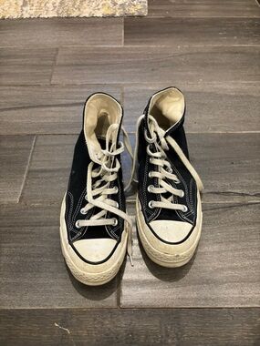 Vans Black and White High-Top Sneakers
Unisex was seldom used.